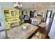 Eat-in kitchen featuring stainless steel appliances, an island with seating, and views to the open floor plan at 5473 Forest Glen Dr, Brownsburg, IN 46112