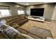 Spacious living room features a large gray sectional sofa and entertainment center at 5473 Forest Glen Dr, Brownsburg, IN 46112