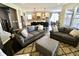 Inviting living room with plush sofas, an ottoman, and an open concept design leading to the kitchen and dining area at 5473 Forest Glen Dr, Brownsburg, IN 46112