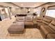 Spacious living room features a large gray sectional sofa, an entertainment area, and bar seating at 5473 Forest Glen Dr, Brownsburg, IN 46112