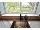Stainless steel sink has a black faucet with a beautiful view out the window at 5473 Forest Glen Dr, Brownsburg, IN 46112