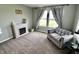 Cozy bedroom sitting area with decorative fireplace and stylish curtains at 5473 Forest Glen Dr, Brownsburg, IN 46112