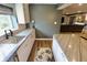 This wet bar features stainless steel sink, stone countertops, and modern finishes at 5473 Forest Glen Dr, Brownsburg, IN 46112