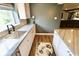 This wet bar features gray stone countertops, stainless steel sink, and white cabinetry at 5473 Forest Glen Dr, Brownsburg, IN 46112