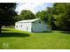 Large barn with white siding nestled on a well manicured lawn among mature trees at 5586 S 200 E, Franklin, IN 46131