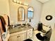 Bathroom with unique mirrors, sink with granite countertop, and toilet with a stylish black rug at 5586 S 200 E, Franklin, IN 46131