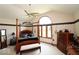 Spacious bedroom featuring a four-poster bed and large windows, filling the room with natural light at 5586 S 200 E, Franklin, IN 46131
