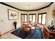 Cozy dining area featuring a round glass table, seating for six, and natural light from surrounding windows at 5586 S 200 E, Franklin, IN 46131