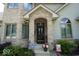 Inviting front entrance with brick accents, manicured greenery, and a decorative storm door at 5586 S 200 E, Franklin, IN 46131