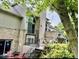 Back of home featuring a brick patio and black iron railings with access to upper balcony at 5586 S 200 E, Franklin, IN 46131
