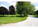 Beautiful front yard featuring mature trees and a well-maintained lawn, enhancing curb appeal at 5586 S 200 E, Franklin, IN 46131