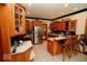Well-lit kitchen features stainless steel appliances, wooden cabinetry, tile backsplash, and an eat-in bar at 5586 S 200 E, Franklin, IN 46131