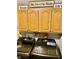 Laundry room with modern black washer and dryer with brown cabinets and sports themed decor at 5586 S 200 E, Franklin, IN 46131