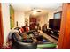 Inviting living room featuring a black leather sofa, large screen TV, and vibrant decor, perfect for relaxing at 5586 S 200 E, Franklin, IN 46131
