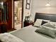Bedroom showing a King size bed, dresser with TV, closet with hanging ties, and en suite bath at 5586 S 200 E, Franklin, IN 46131