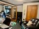 Open home office with glass doors, pool table rug and comfortable seating at 5586 S 200 E, Franklin, IN 46131