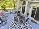 Outdoor patio featuring modern furniture, stylish rug, brick accents, and access to home interior at 5586 S 200 E, Franklin, IN 46131