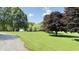 Expansive, well-maintained lawn with mature trees on a sunny day at 5586 S 200 E, Franklin, IN 46131