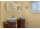 Elegant bathroom featuring dual vessel sinks, decorative mirrors, and a stylish chandelier at 5631 Shelby St, Indianapolis, IN 46227