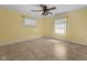 Bright bedroom featuring neutral walls, tile floors, and a ceiling fan at 5631 Shelby St, Indianapolis, IN 46227