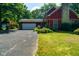 Charming two-story home with a stone chimney, attached garage, and professionally landscaped yard at 5631 Shelby St, Indianapolis, IN 46227