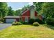 Charming two-story home with a stone chimney, attached garage, and professionally landscaped yard at 5631 Shelby St, Indianapolis, IN 46227