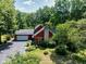 Charming two-story home with a stone chimney, attached garage, and professionally landscaped yard at 5631 Shelby St, Indianapolis, IN 46227