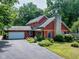 Charming two-story home with a stone chimney, attached garage, and professionally landscaped yard at 5631 Shelby St, Indianapolis, IN 46227
