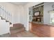 Inviting foyer with stairs leading to a stone fireplace in the living room at 5631 Shelby St, Indianapolis, IN 46227