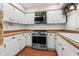 Well-maintained kitchen featuring white cabinets, stainless steel range, and practical countertops at 5631 Shelby St, Indianapolis, IN 46227