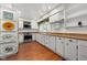 Bright, traditional kitchen features white cabinets, stainless steel appliances and wood-look flooring at 5631 Shelby St, Indianapolis, IN 46227