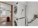 Efficient laundry area with stacked washer and dryer, utility sink, and organized space at 5631 Shelby St, Indianapolis, IN 46227