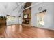 Bright living room with hardwood floors, stone fireplace, and natural light from large windows at 5631 Shelby St, Indianapolis, IN 46227