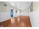 Bright living room featuring hardwood floors, beadboard walls, and a ceiling fan at 5631 Shelby St, Indianapolis, IN 46227