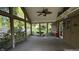 Spacious screened-in porch with ceiling fan and views of the backyard at 5631 Shelby St, Indianapolis, IN 46227