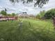 Spacious backyard with a swing set, basketball hoop, and fenced yard at 621 Appleseed Way, Indianapolis, IN 46217