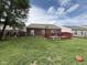 Large backyard featuring a swing set, basketball hoop, and a fenced yard at 621 Appleseed Way, Indianapolis, IN 46217