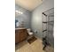 Bathroom with tile flooring, a single vanity, and shelving unit for storage at 621 Appleseed Way, Indianapolis, IN 46217