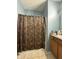 Simple bathroom featuring a floral shower curtain and a single sink vanity at 621 Appleseed Way, Indianapolis, IN 46217
