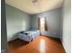 Minimalist bedroom with hardwood floors and natural light from the window at 621 Appleseed Way, Indianapolis, IN 46217