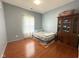 Clean bedroom featuring light blue walls and hardwood flooring at 621 Appleseed Way, Indianapolis, IN 46217