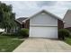 Charming brick home featuring an attached two-car garage and well-maintained landscaping at 621 Appleseed Way, Indianapolis, IN 46217