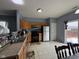 Well-lit kitchen featuring wooden cabinetry, stainless steel appliances, and backyard access at 621 Appleseed Way, Indianapolis, IN 46217