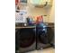 Modern laundry room featuring front loading washer and dryer with folding table at 621 Appleseed Way, Indianapolis, IN 46217
