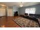 Cozy living room featuring wood floors, a chandelier, and comfortable seating at 621 Appleseed Way, Indianapolis, IN 46217