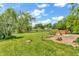 Lush backyard with mature trees, a scenic pond, and a hot tub for ultimate relaxation at 6329 Whitaker Farms Dr, Indianapolis, IN 46237
