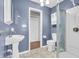 Cozy bathroom featuring a pedestal sink, white fixtures, and a standing shower, offering essential amenities at 6329 Whitaker Farms Dr, Indianapolis, IN 46237