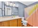 Bright bathroom features a vanity, mirror, and shower with colorful curtains at 6329 Whitaker Farms Dr, Indianapolis, IN 46237