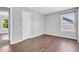 Bedroom with hardwood flooring showcases a window with a view and a closet door at 6329 Whitaker Farms Dr, Indianapolis, IN 46237
