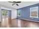This bedroom features hardwood floors, a ceiling fan, and ample natural light, creating a relaxing retreat at 6329 Whitaker Farms Dr, Indianapolis, IN 46237